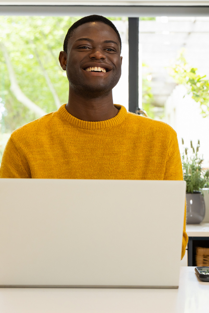 Thriving Desk - African Man with a Laptop